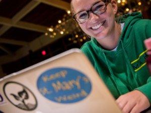 girl with cool sustainability stickers on laptop