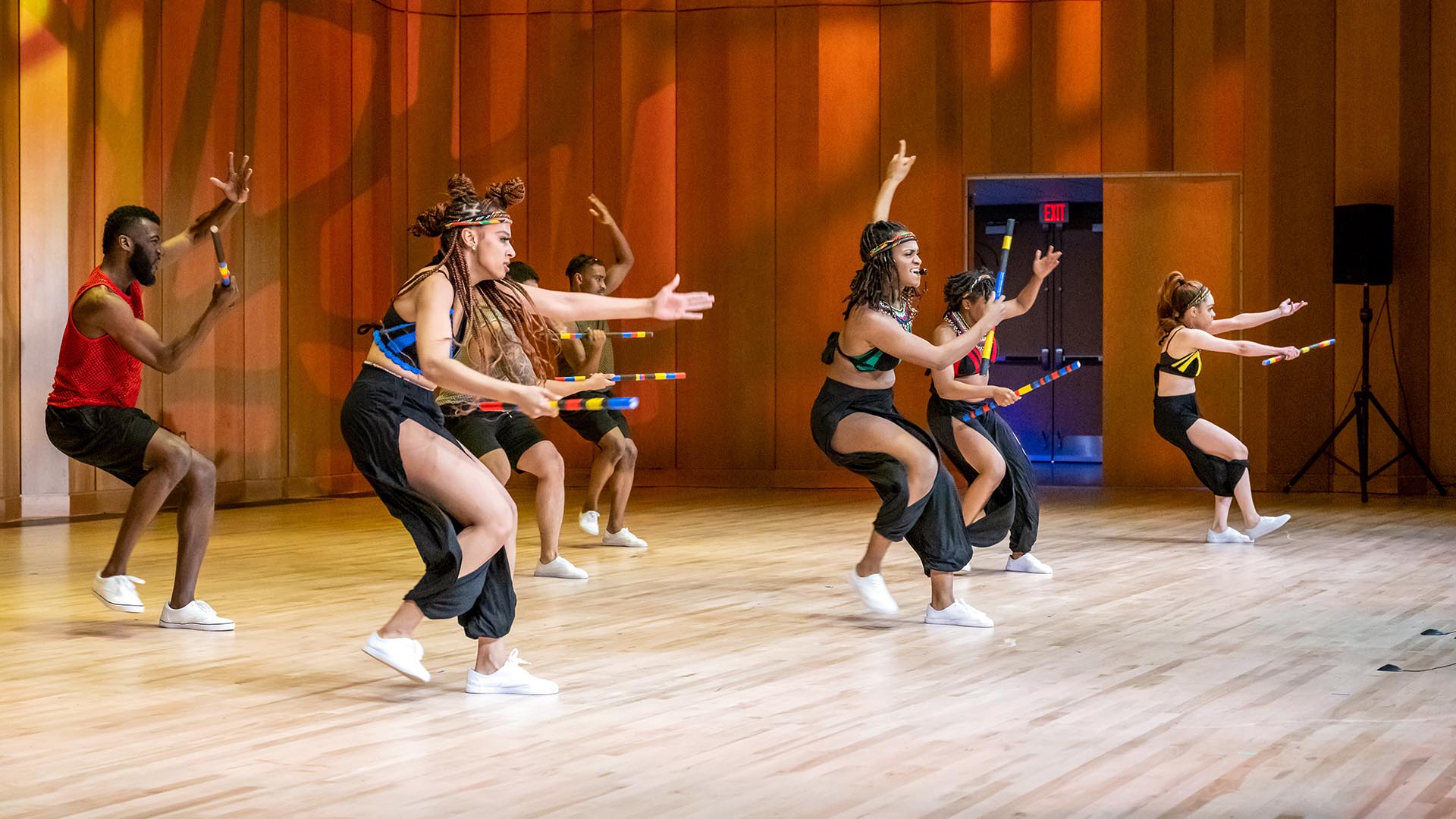 African dancers performing on stage at the Nancy R. and Norton T. Dodge auditorium.
