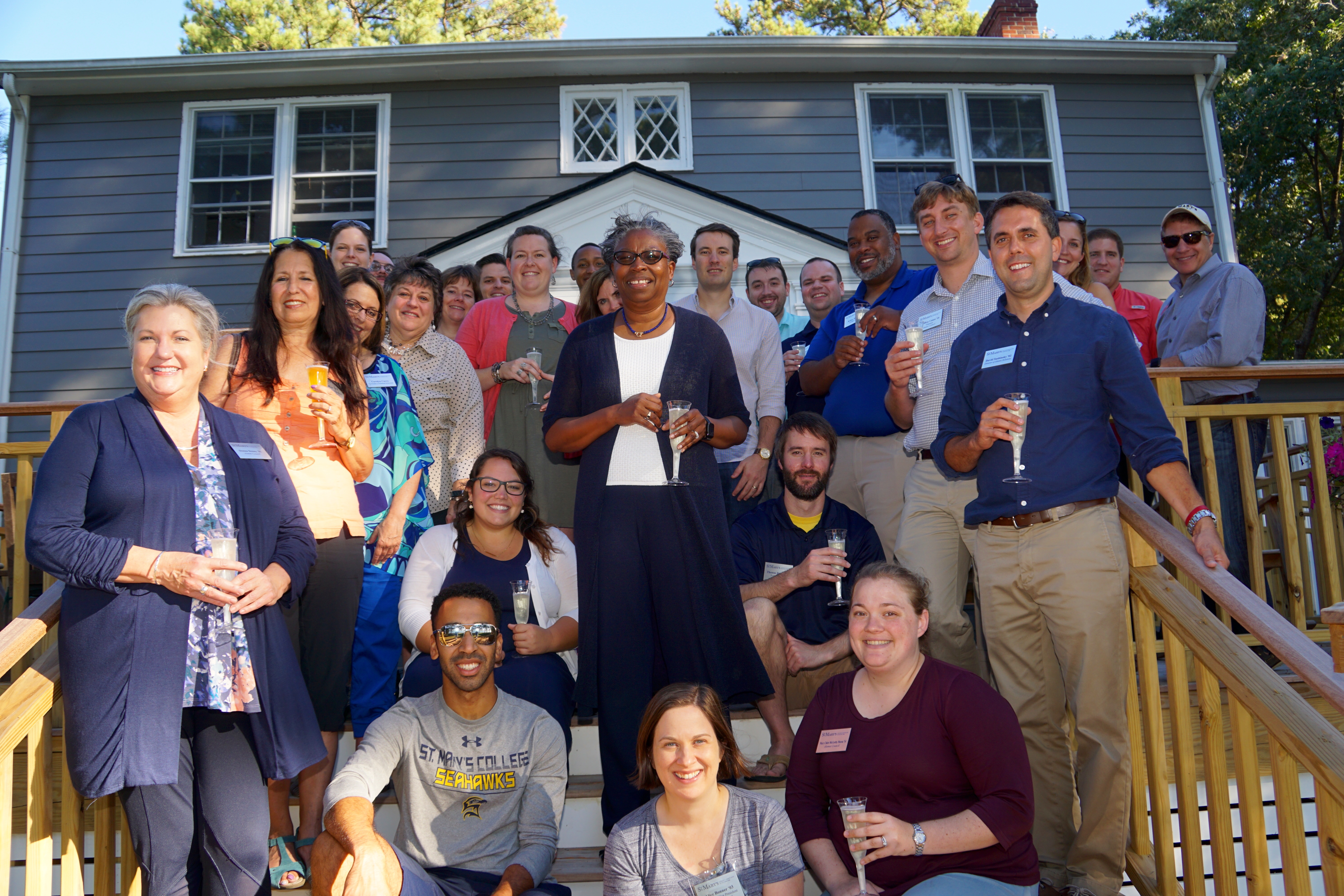 The Alumni Council and the SMCM President taking a group photo in front of the Cobb House 